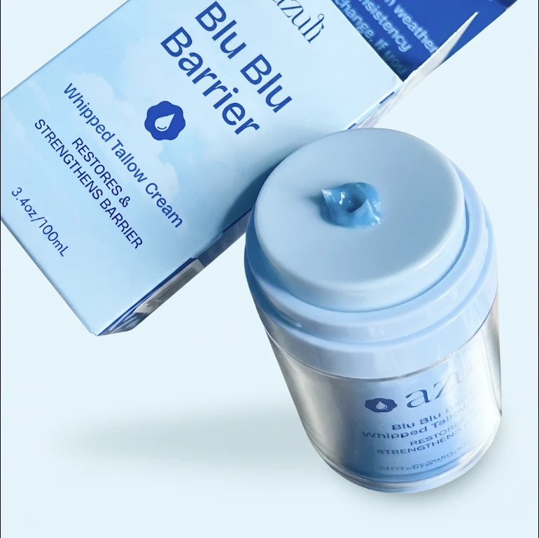 Blu Blu Barrier jar beside its box, a dollop of blue cream on the pump, the inner jar visible through the clear outer jar